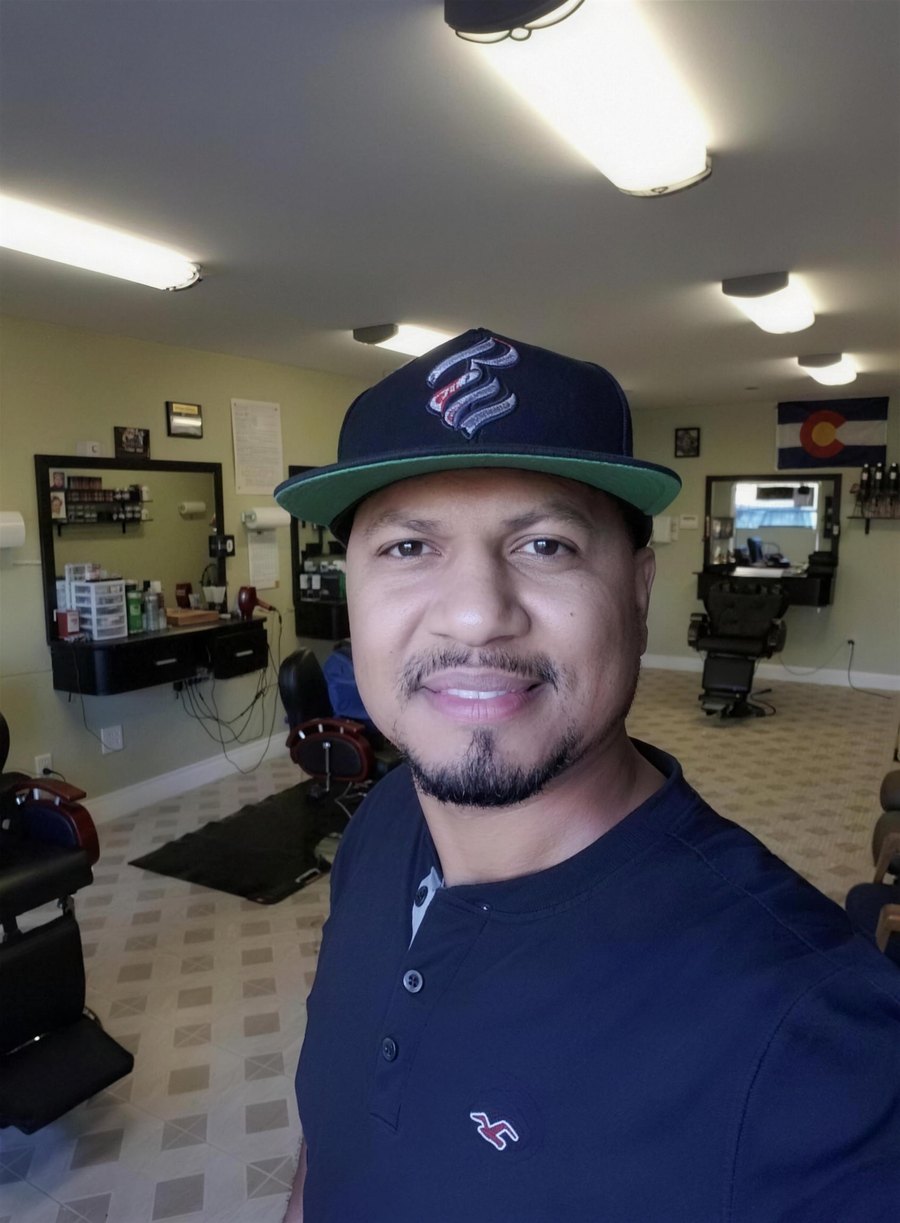 Emilio Resendiz, owner of Champ's Barber Shop, standing in the shop